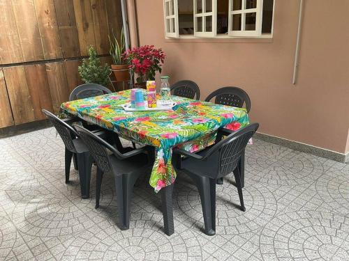 a black table with a colorful table cloth on it at La Maison de Paofai in Papeete