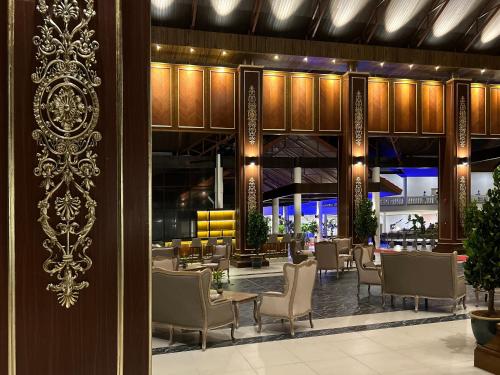 a lobby with chairs and tables in a building at Damai Lagoon Resort in Santubong