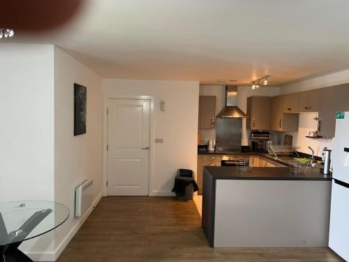 a kitchen with a table and a counter top at Heronsgate GH014 in Belvedere