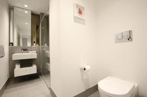 ein Bad mit einem WC und einem Waschbecken in der Unterkunft Brand New 2BR Apt at Mel CBD in Melbourne