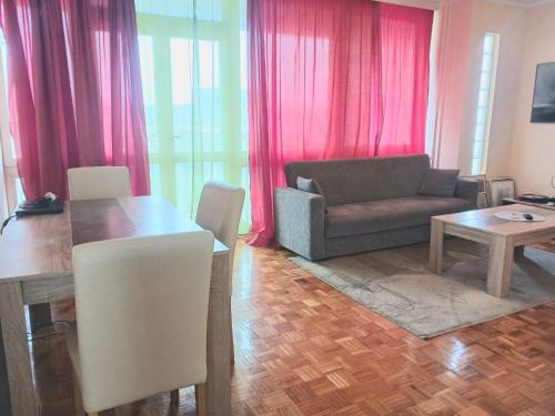 un soggiorno con divano e tavolo di Comfort Apartment a Novi Beograd