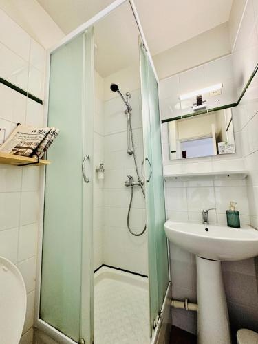 a bathroom with a shower and a sink at Hotel Le Midi Clermont-Cournon in Cournon-dʼAuvergne