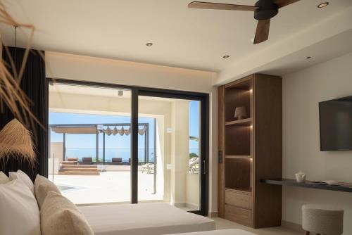 a bedroom with a sliding glass door to a patio at Fodele Beach Water Park Resort in Fodele
