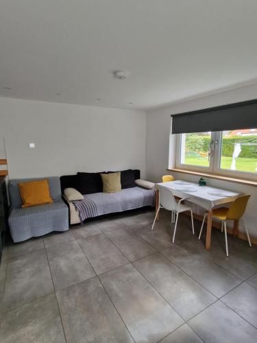 a living room with a couch and a table at Modern two bedroom house 