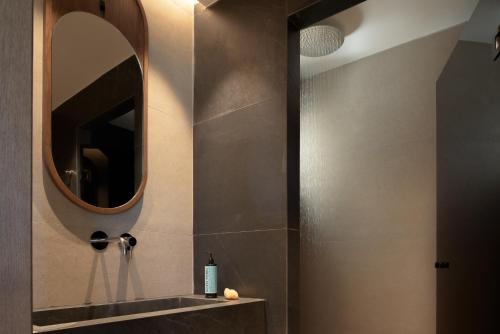 a bathroom with a mirror and a sink at Fodele Beach Water Park Resort in Fodele