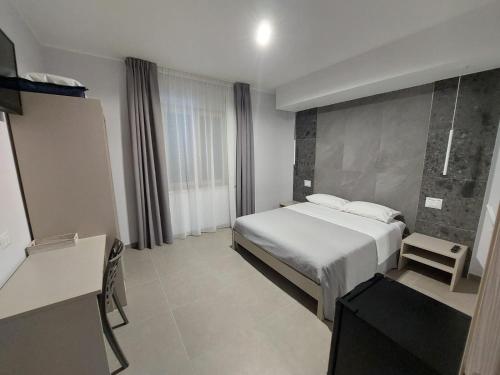 a hotel room with a bed and a desk at Residenza Elba - Charme House in Termoli