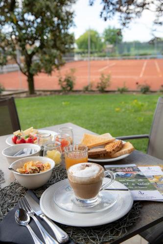 a table with food and a cup of coffee and toast at Ancora Sport Resort Hotel in Meolo