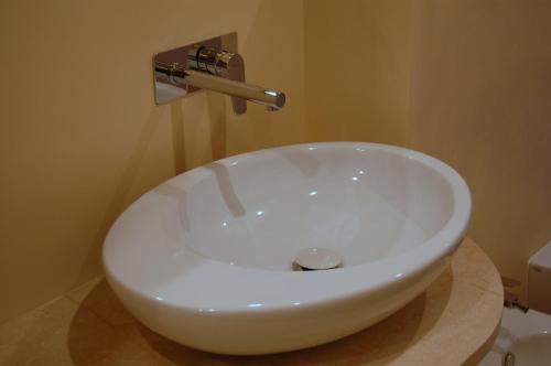 a white sink in a bathroom next to a toilet at La Corte Fiorita Como in Como