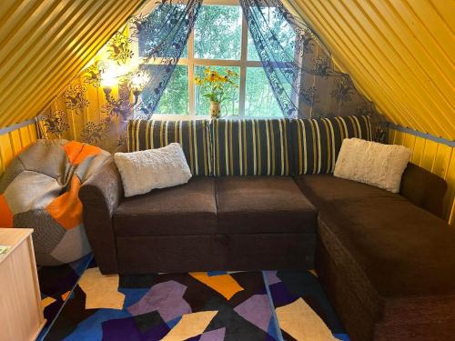 a living room with a couch and a window at Valgemaja Majutus in Restu
