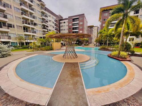 a swimming pool with a fountain in the middle of a building at * * L Iloilo's Quirky Oasis in Iloilo City