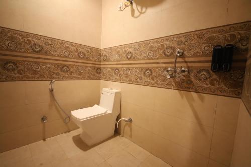 a bathroom with a toilet and a shower at Perfectstayz Value Homes Mussoorie 120 meters uphill in Mussoorie