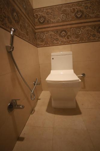 a bathroom with a toilet in a bathroom stall at Perfectstayz Value Homes Mussoorie 120 meters uphill in Mussoorie