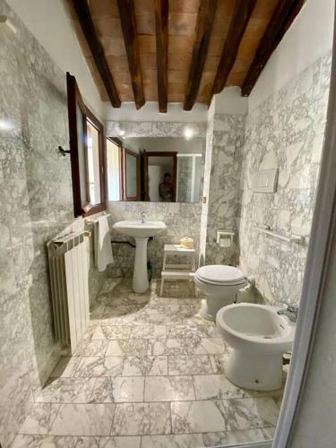 a bathroom with a toilet and a sink at Alle Casine in Lucca