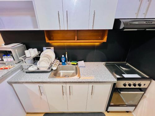 a kitchen with a sink and a stove at * *M Your Iloilo City Sanctuary in Iloilo City