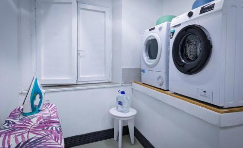 a laundry room with a washing machine and a table at Hotel Porta Palio in Verona