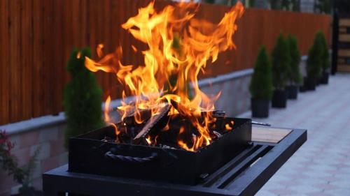 a fire in a grill with flames in it at Star Villa Bakuriani in Bakuriani