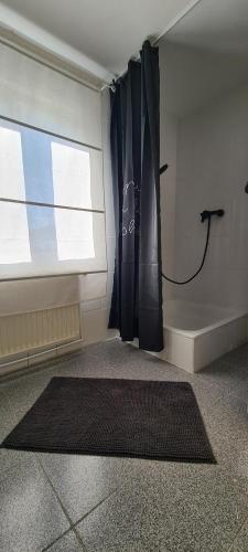 a room with a window and a black umbrella at Petit Castel in Bran
