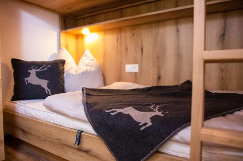 a bedroom with a bunk bed with a reindeer blanket at Kitzlochklammblick Hof in Taxenbach