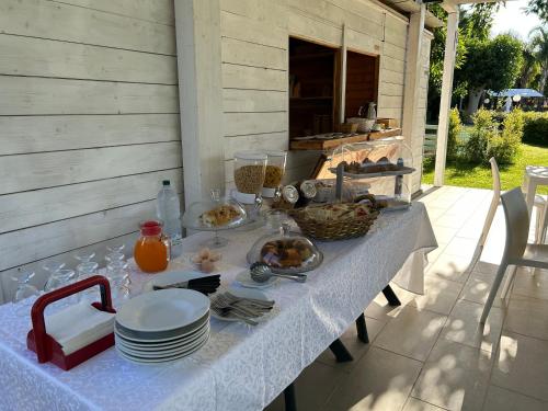 a table with plates and bowls of food on it at Hotel Park in Rossano