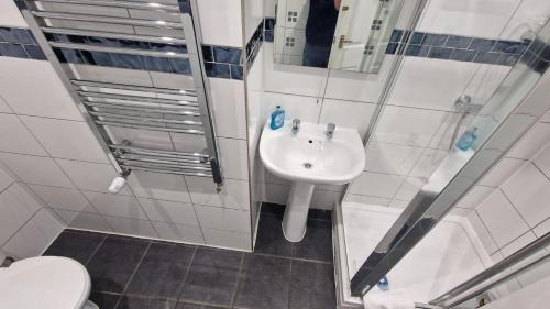 a bathroom with a sink and a toilet at Rutland Point Studio serviced accommodation Keystones Property Services in Morcott