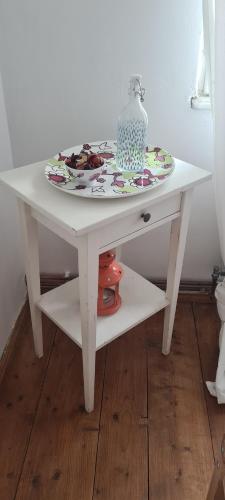 a white table with a plate on top of it at Petit Castel in Bran