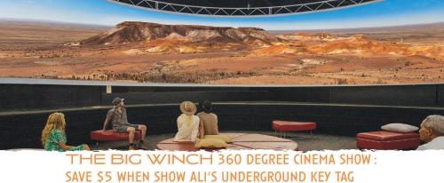 a group of people sitting on a stage looking at a view at Ali's Underground Home in Coober Pedy