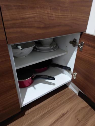 a drawer in a kitchen cabinet with dishes and utensils at 043AKIHABARA in Tokyo