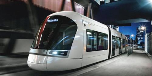 a white subway train on the tracks at night at Isramax Jerusalem Apartment in Bat-Yam in Bat Yam