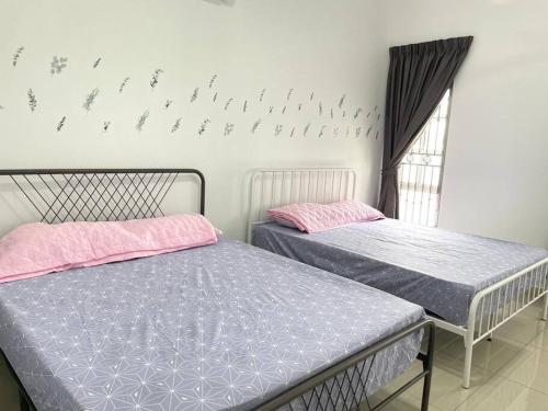 two beds in a room with birds on the wall at No7 Port Dickson Telok Kemang 15PAX BBQ Big Family in Port Dickson