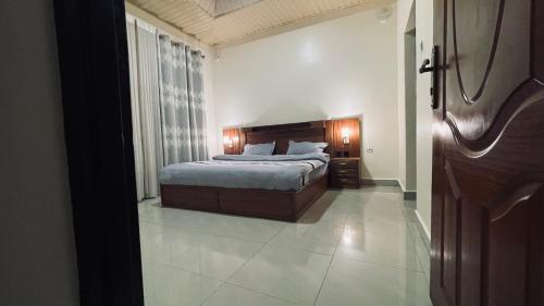 ein Schlafzimmer mit einem Bett in einem Zimmer in der Unterkunft Rwandeka in Kigali