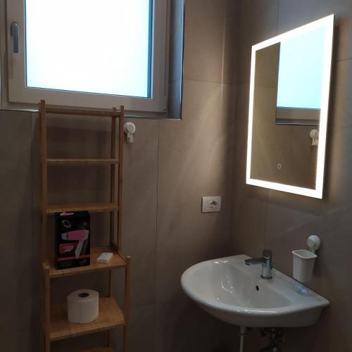a bathroom with a sink and a mirror at STRADONE 132 in Gravina in Puglia