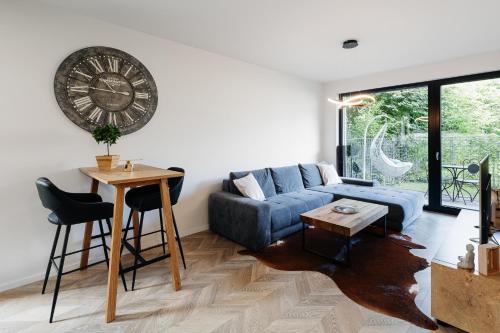 a living room with a blue couch and a table at Garden Apartment in Banská Bystrica