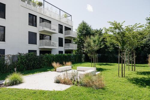 an apartment building with a garden in front of it at Garden Apartment in Banská Bystrica