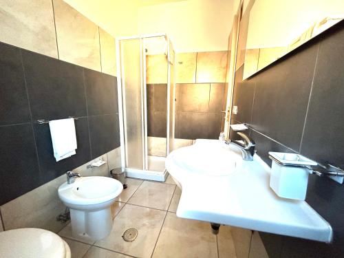 a bathroom with a sink and a toilet and a shower at Hotel Park in Rossano