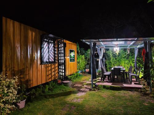 a house with a table and chairs on a patio at Cabinscape - Albay in Malilipot