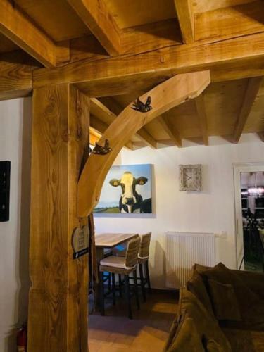 a dining room with a table and a wooden ceiling at Prachtige vakantiewoning met weids uitzicht in Maldegem