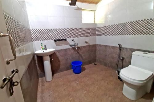 a bathroom with a toilet and a sink at Hazel Retreat - Full Home & Coffee Estate in Chikmagalūr