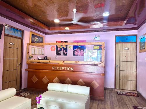 a room with a bar with a reception counter at Galaxy Sunrise Sea View in Fulidhoo