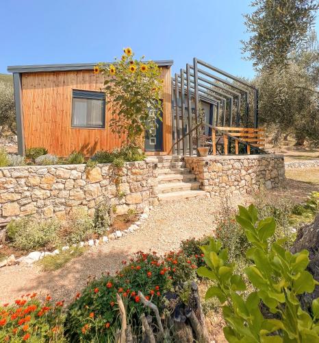 a house with a stone wall and a stone staircase at Mawa Cottage in Ulcinj