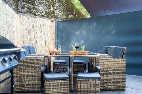 a patio with a table and wicker chairs at Wellnessoase mitten in Triberg in Triberg