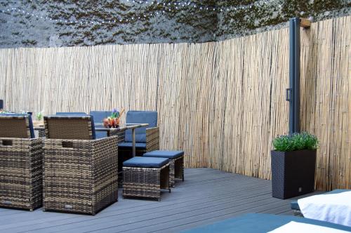 a patio with chairs and a table and a fence at Wellnessoase mitten in Triberg in Triberg