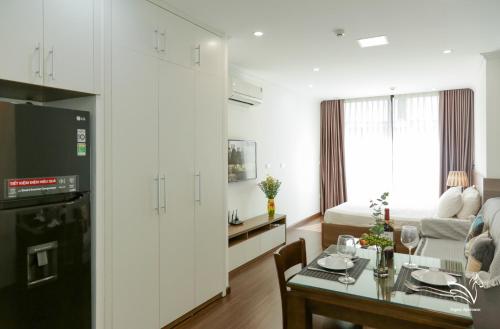 a living room with a kitchen and a dining room at Pegasy Apartments & Travel in Hanoi