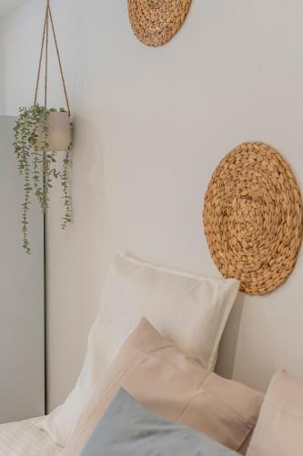 a room with a couch and a pillow and a hat at Chalet Marias - Parede beach apartments in Parede