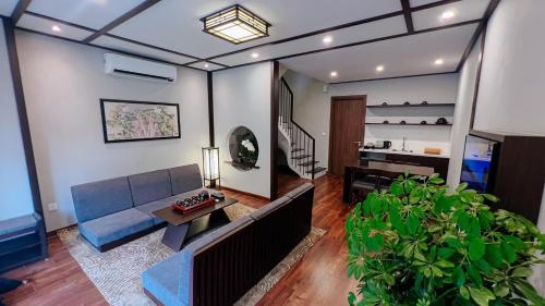 ein Wohnzimmer mit einem Sofa und einem Tisch in der Unterkunft WYNDHAM LYNN TIMES THANH THỦY - KHU NGHỈ DƯỠNG KHOÁNG NÓNG in Phú Thọ