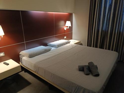 a hotel room with a bed with two towels on it at Suite Apartment Domus Cosenza in Cosenza