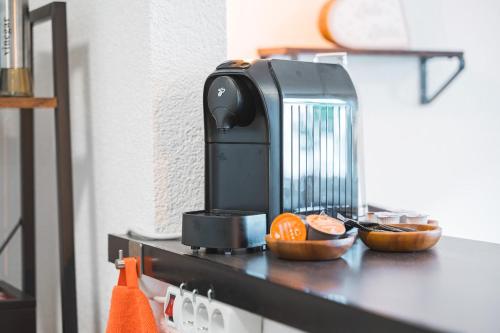 a coffee maker sitting on top of a counter at Roomfall Apartment Sinsheim mit TG & Wi-Fi & Balkon in Sinsheim