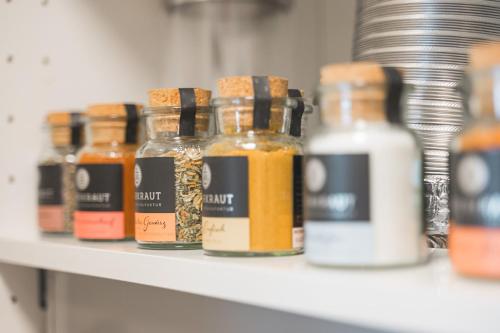 a shelf with several bottles of honey on it at Roomfall Apartment Sinsheim mit TG & Wi-Fi & Balkon in Sinsheim