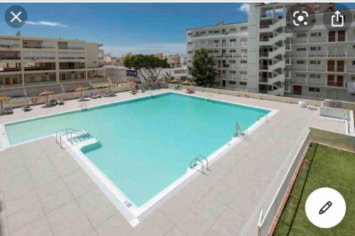 a large swimming pool on the roof of a building at Magnífico Apartamento en La Carihuela, Torremolino in Torremolinos