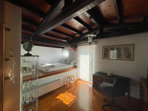 a bedroom with a desk and a bed in a room at Jenny's Villa - Lagonissi in Kalívia Thorikoú