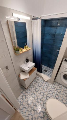 a bathroom with a sink and a shower and a toilet at Comfy and stylish jewelry box in Budapest